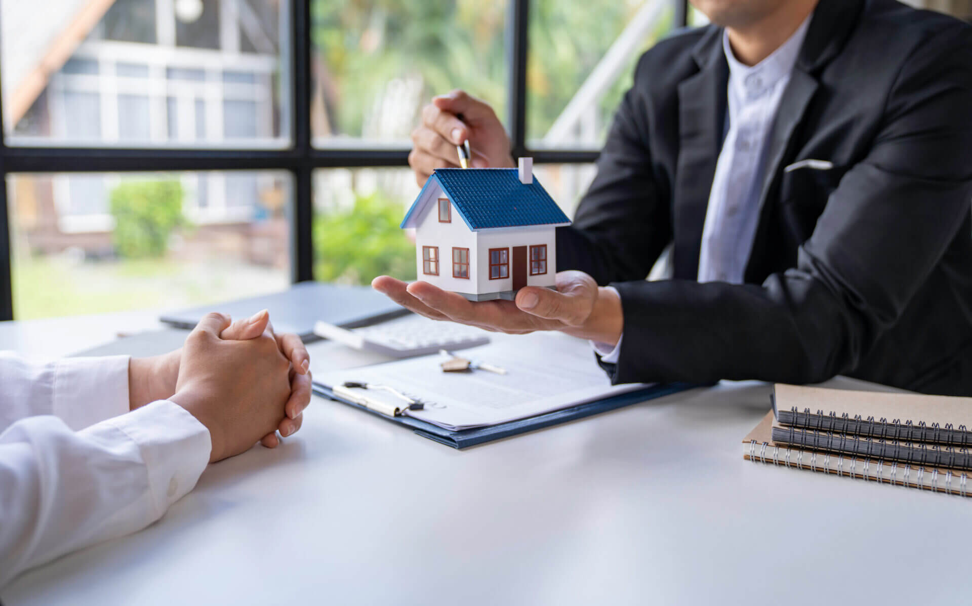 Sale Estate agent are presenting home loan to customer to decisi